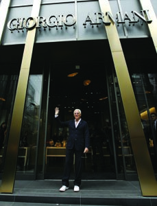 Giorgio Armani infront of one of his flagship stores